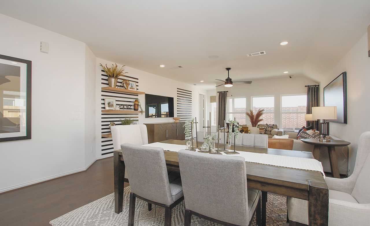 Elegant dining and living room with striped wall accents in Cypress Green community home.