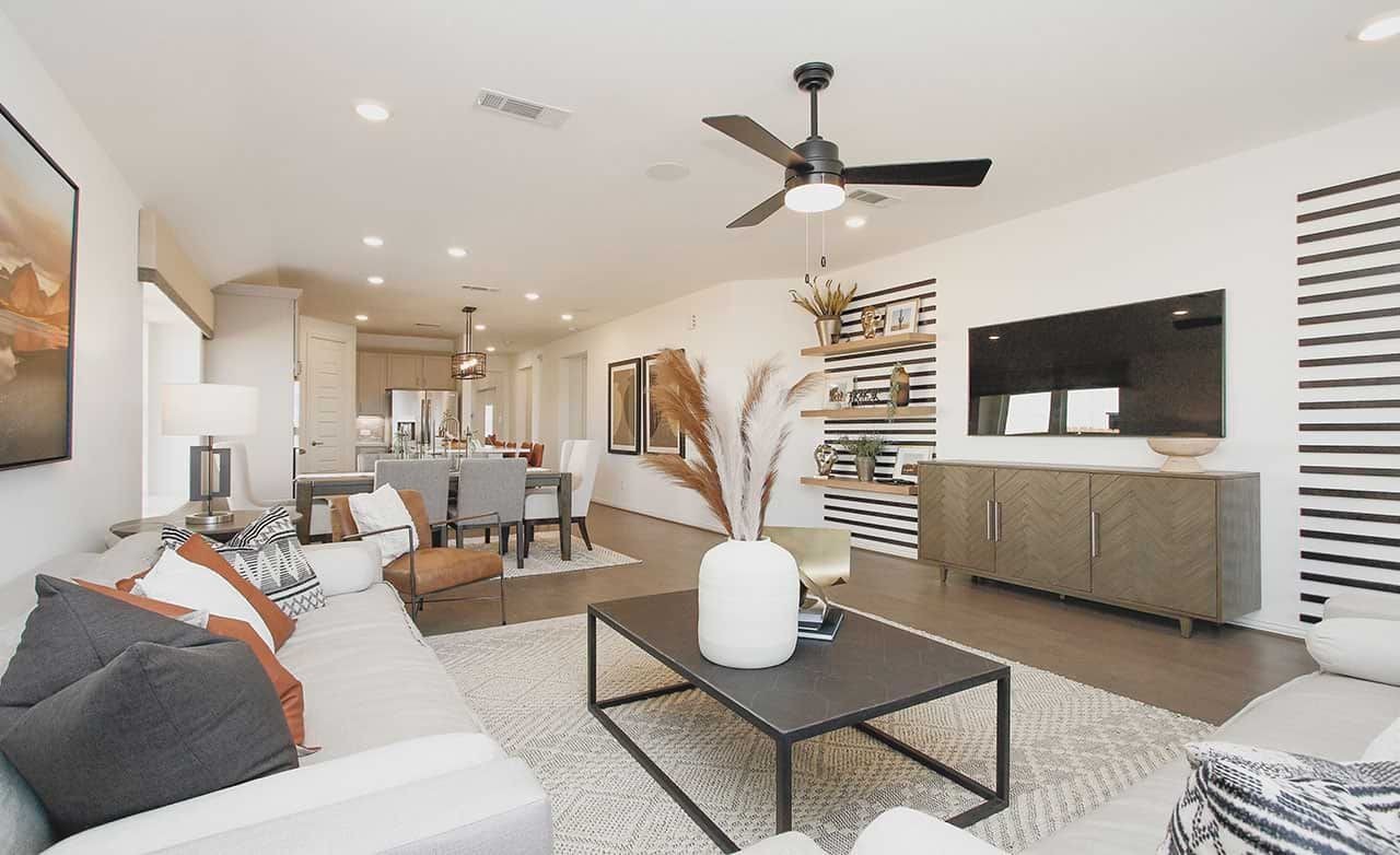 Modern living room with sleek decor, open layout, stylish furniture, in Cypress Green community.