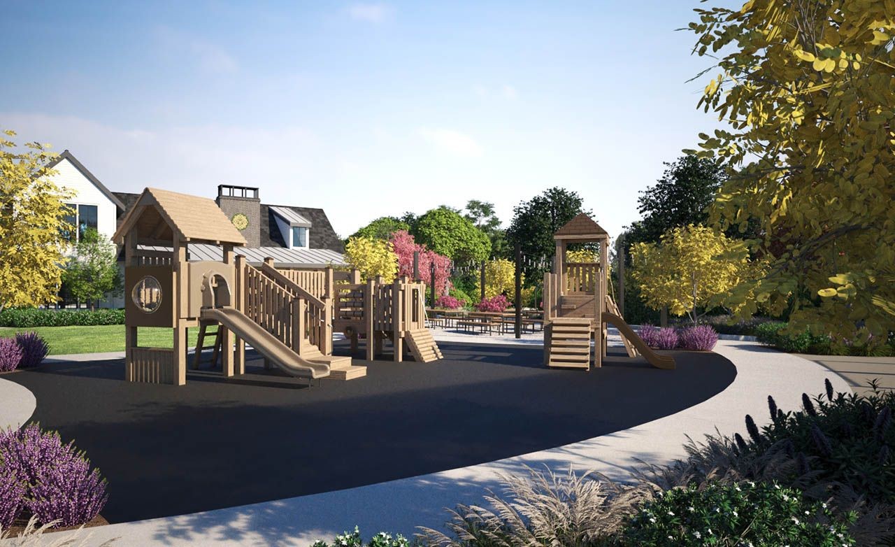 Modern playground with slides, surrounded by lush greenery and colorful trees, Westerly community.