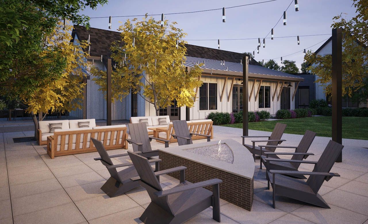 Modern outdoor patio with fire pit, string lights, and Adirondack chairs in Westerly community courtyard.