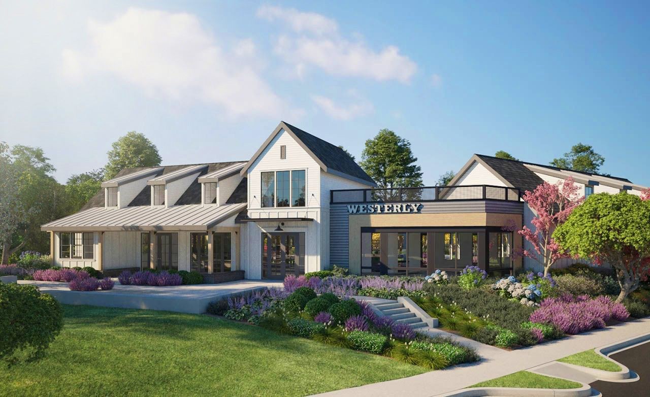 Modern two-story building with gabled roof, large windows, "Westerly" sign. Surrounded by lush landscaping.