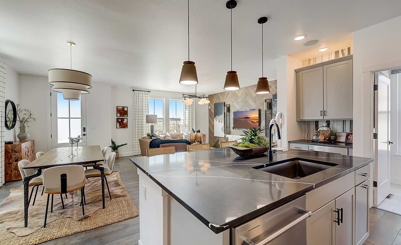 Modern open kitchen and dining in luxury home, featuring sleek countertops, pendant lighting, and natural light, Westerly.
