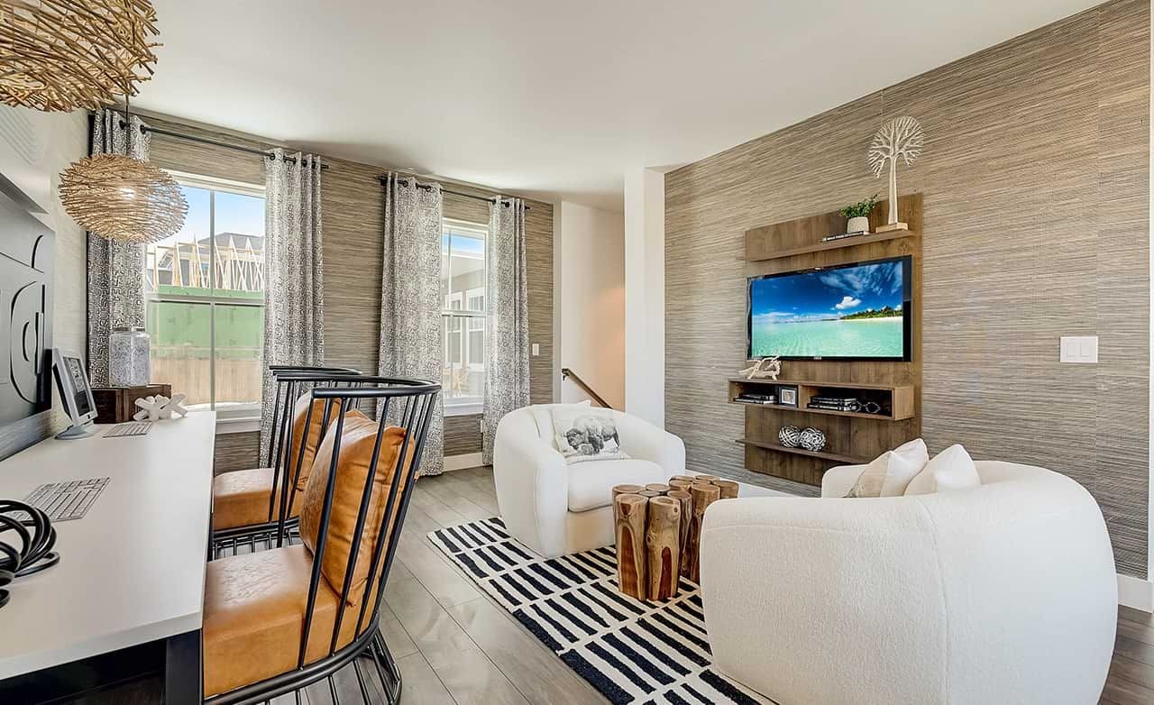 Modern living room with wicker pendant light, wood shelves, and accent wall in Denver home.