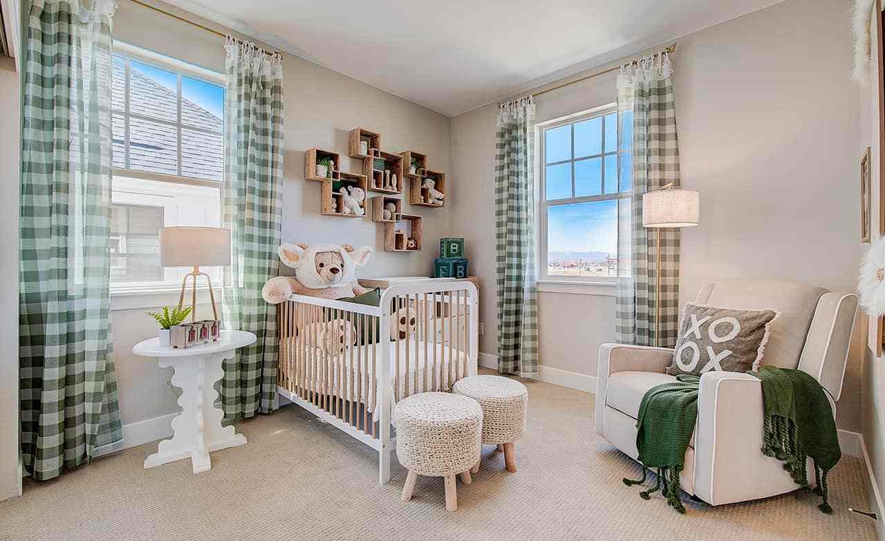 Luxurious nursery with plush toys, checkered curtains, white crib, armchair in Westerly community.