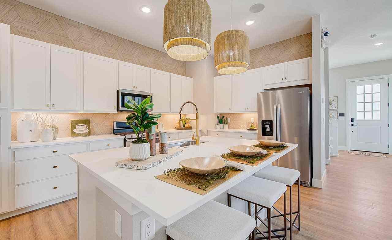 Modern kitchen with white cabinets, large island, pendant lights, stainless steel appliances in Westerly.