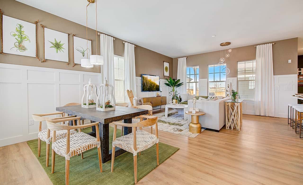 Stylish open living room in Westerly with modern decor, wooden floors, and large windows.