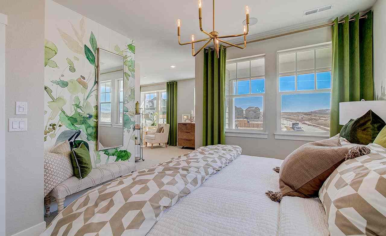 Elegant bedroom with green curtains, floral mural, modern chandelier. Westerly location.