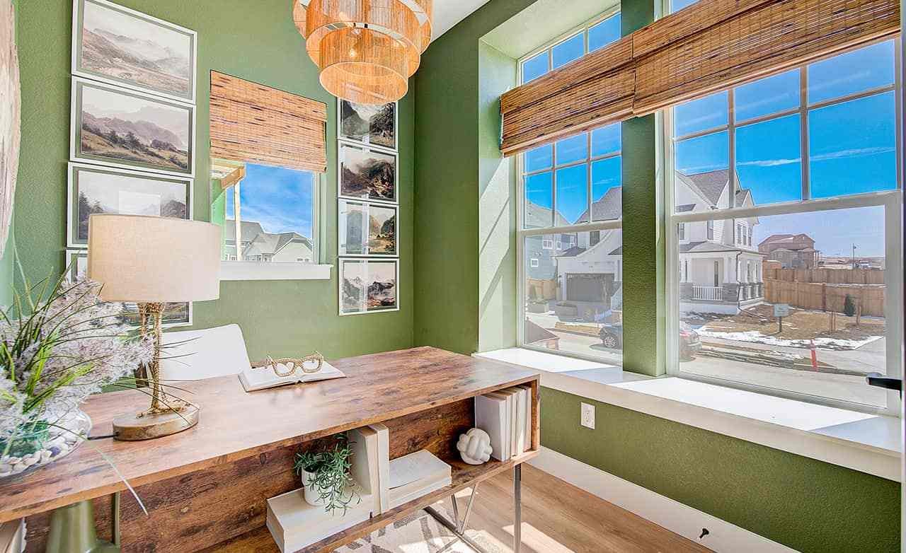Home office, wooden desk, green walls, large windows, Westerly community views, natural light, modern decor.