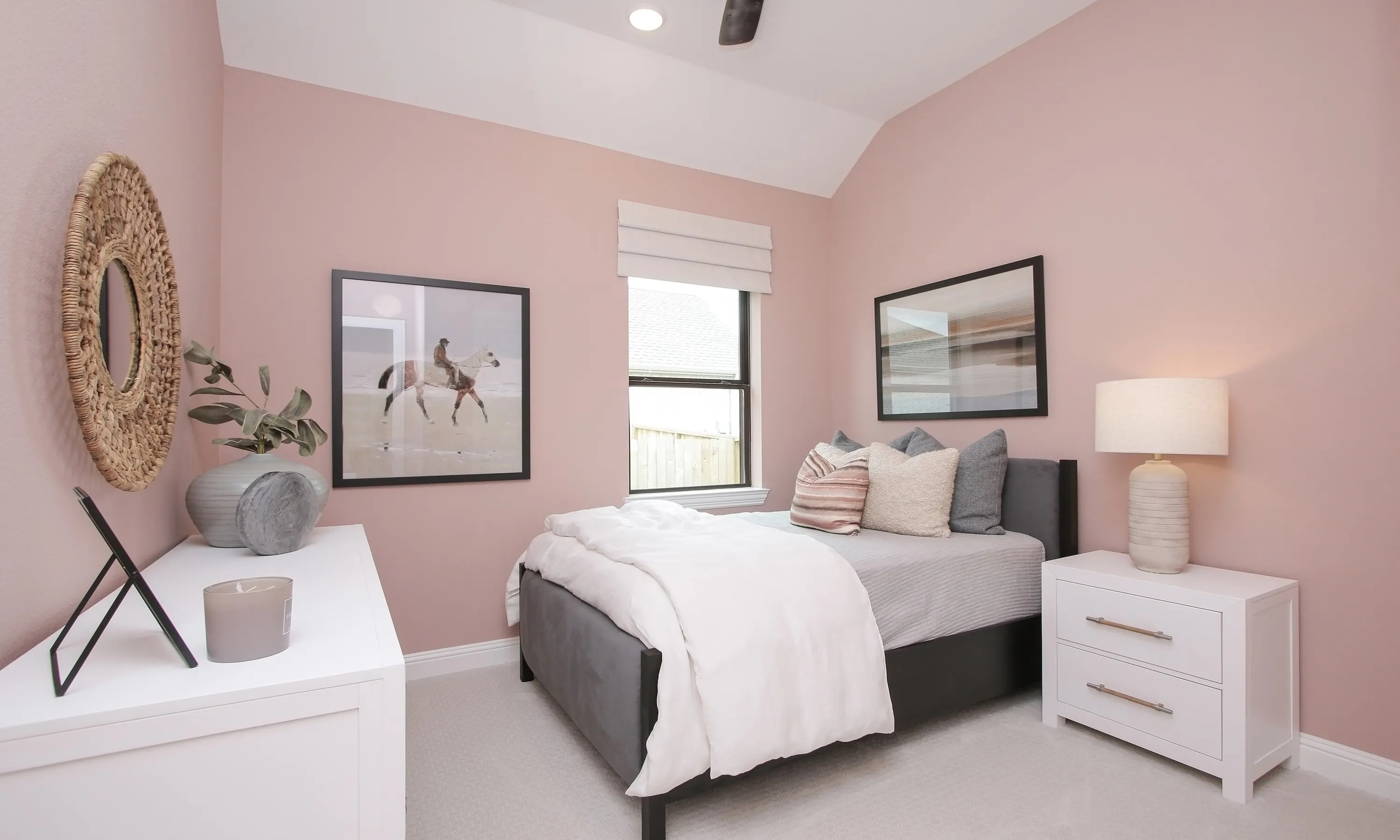 Elegant Bedroom in Coastal Point Community with Pink Walls Elegant bedroom with pink walls, cozy bed, large window, and stylish decor in Coastal Point community.