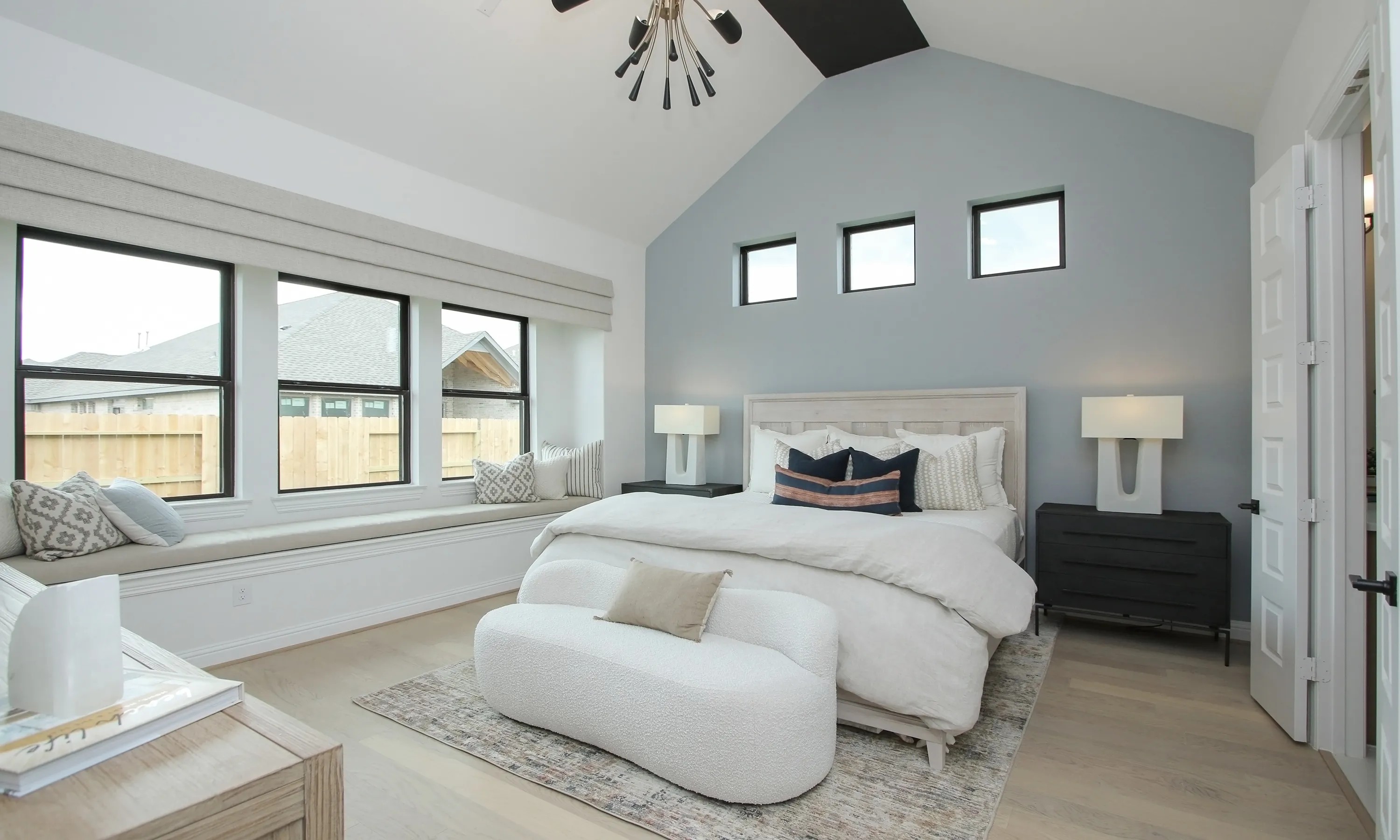 Modern Coastal Point Bedroom with Vaulted Ceiling and Stylish Decor Modern bedroom with vaulted ceiling, elegant lighting, large windows in Coastal Point. Stylish decor enhances luxury.