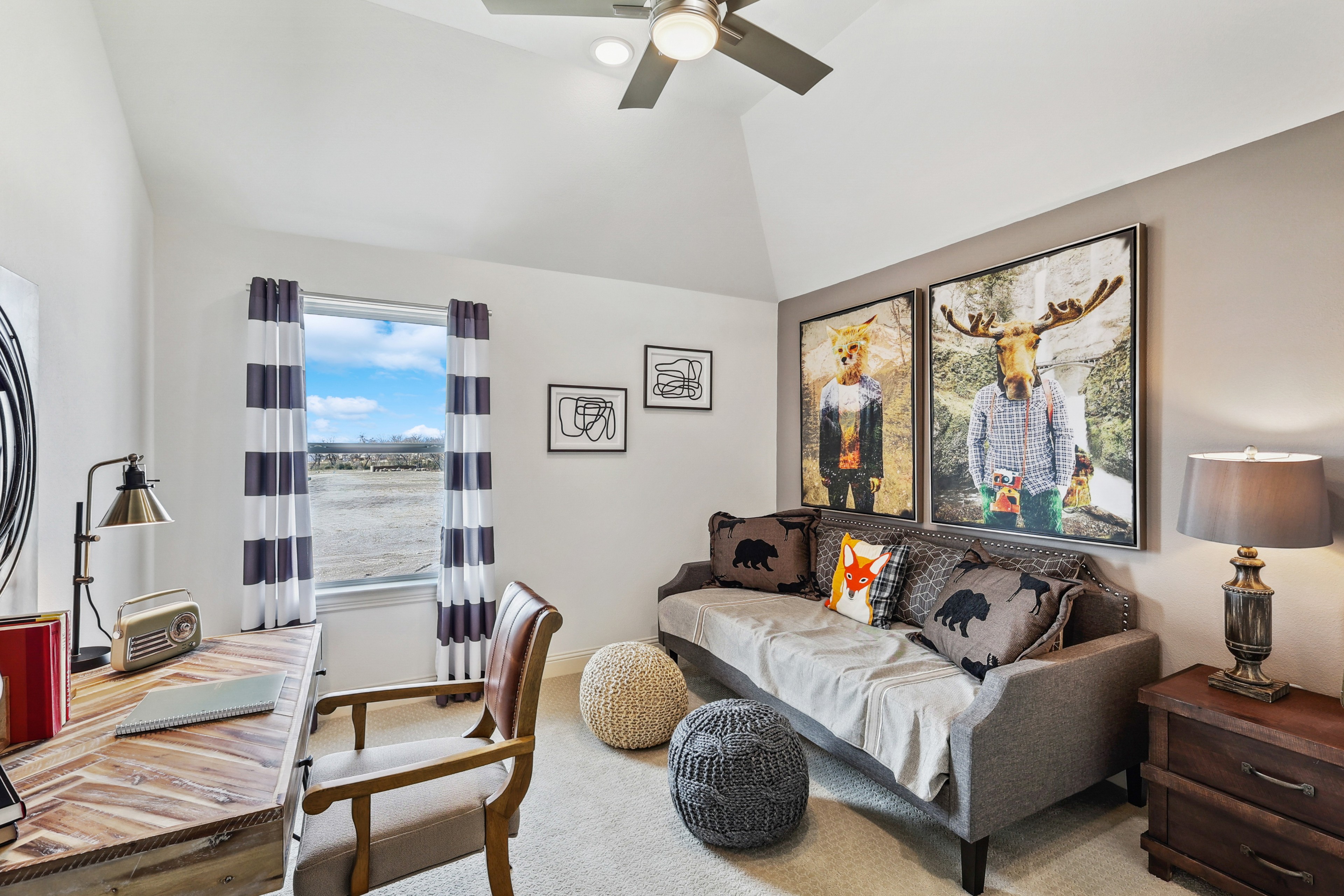Stylish Study Room in Solterra Texas Community Home Cozy Texas study room with rustic desk, plush sofa, playful art, vibrant views. Solterra community home design.