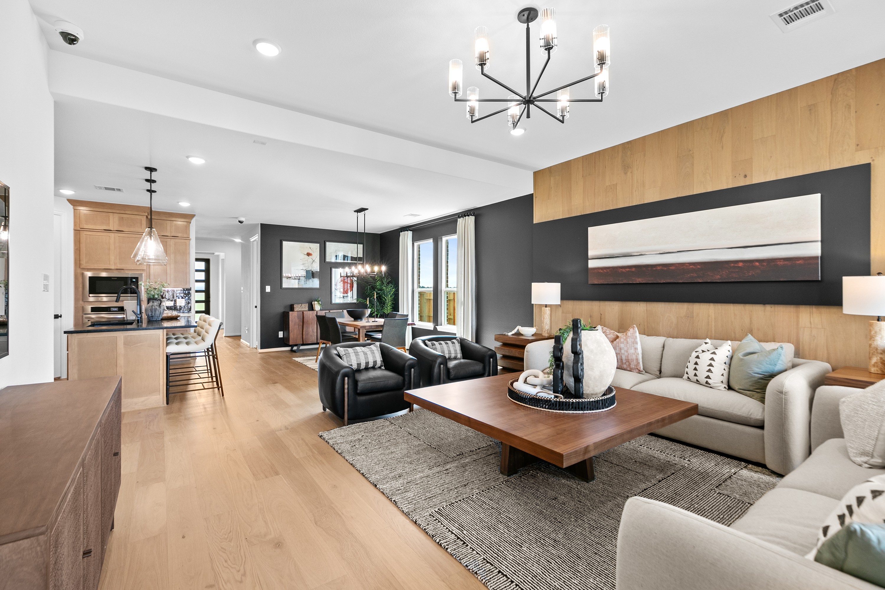 Modern Living Room Design in River Ranch with Elegant Lighting Luxurious modern living room in River Ranch with wood accents, elegant lighting, and open layout. Dining area visible.