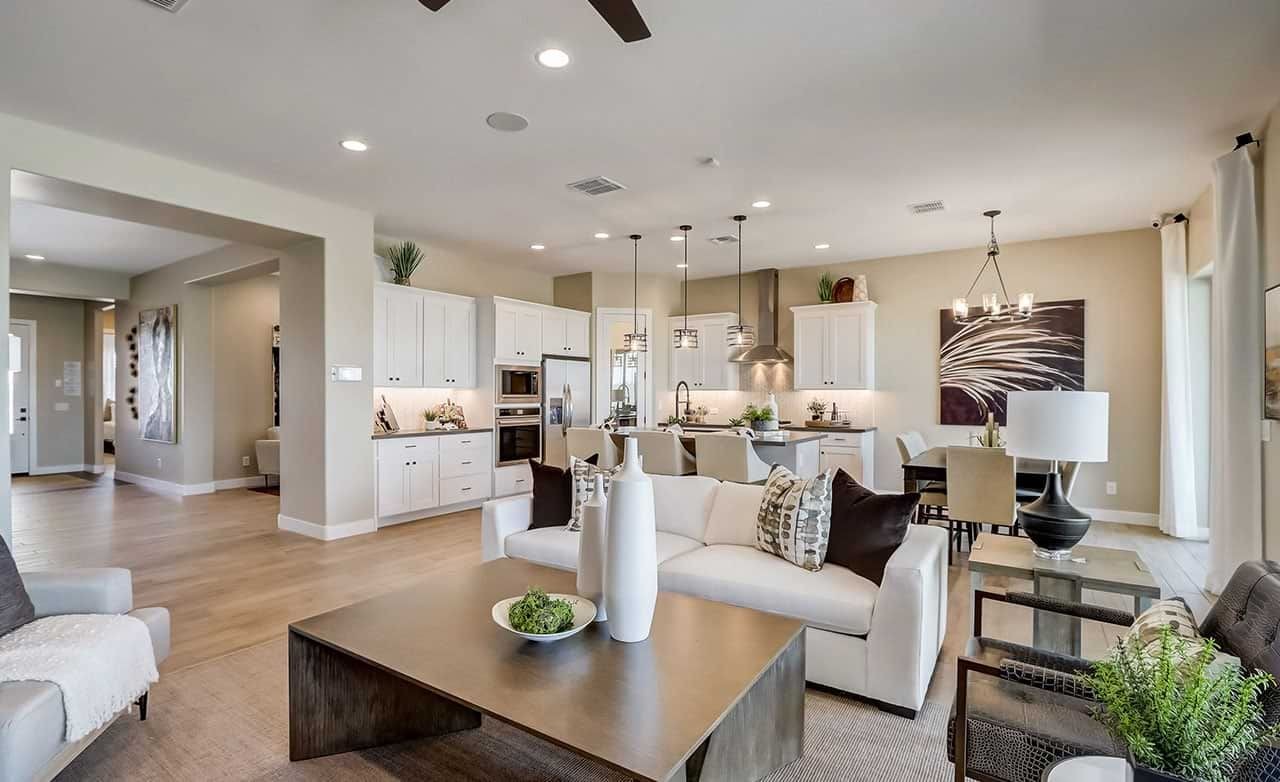 Open-Plan Living and Kitchen with Modern Decor in Canyon Views Hacienda Elegant open-plan living room and kitchen, white cabinetry, hanging lights, modern decor, Canyon Views Hacienda.