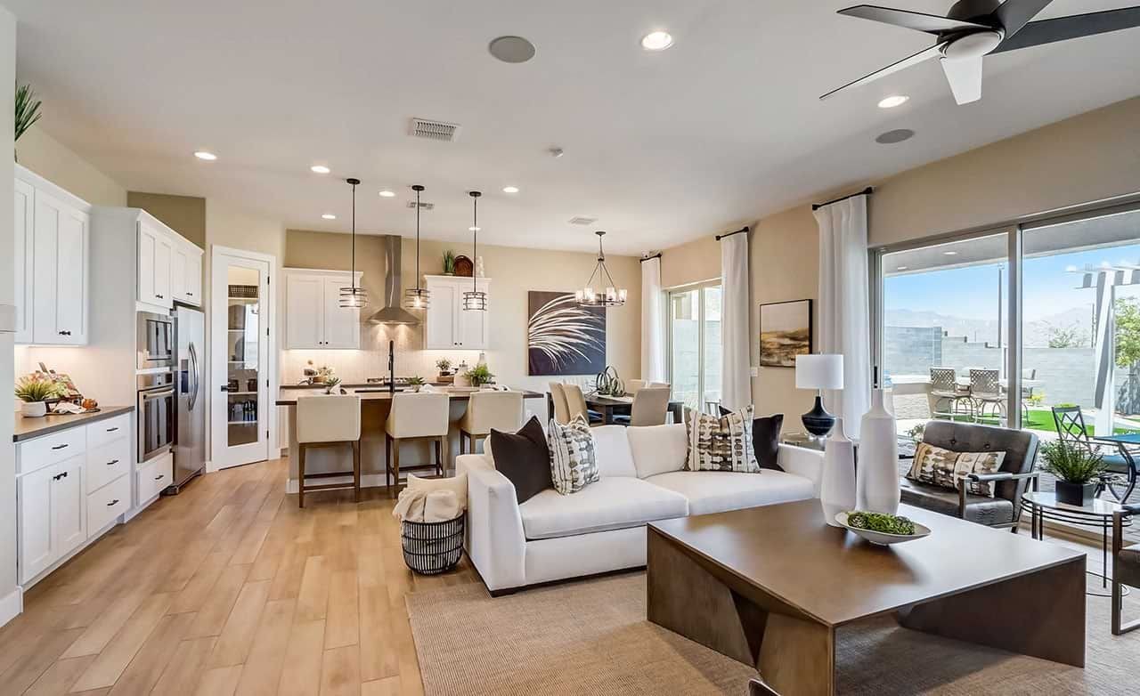 Modern Living Room and Kitchen in Hacienda with Canyon Views Spacious living room with modern decor, hardwood floors, open kitchen, large windows in Hacienda.