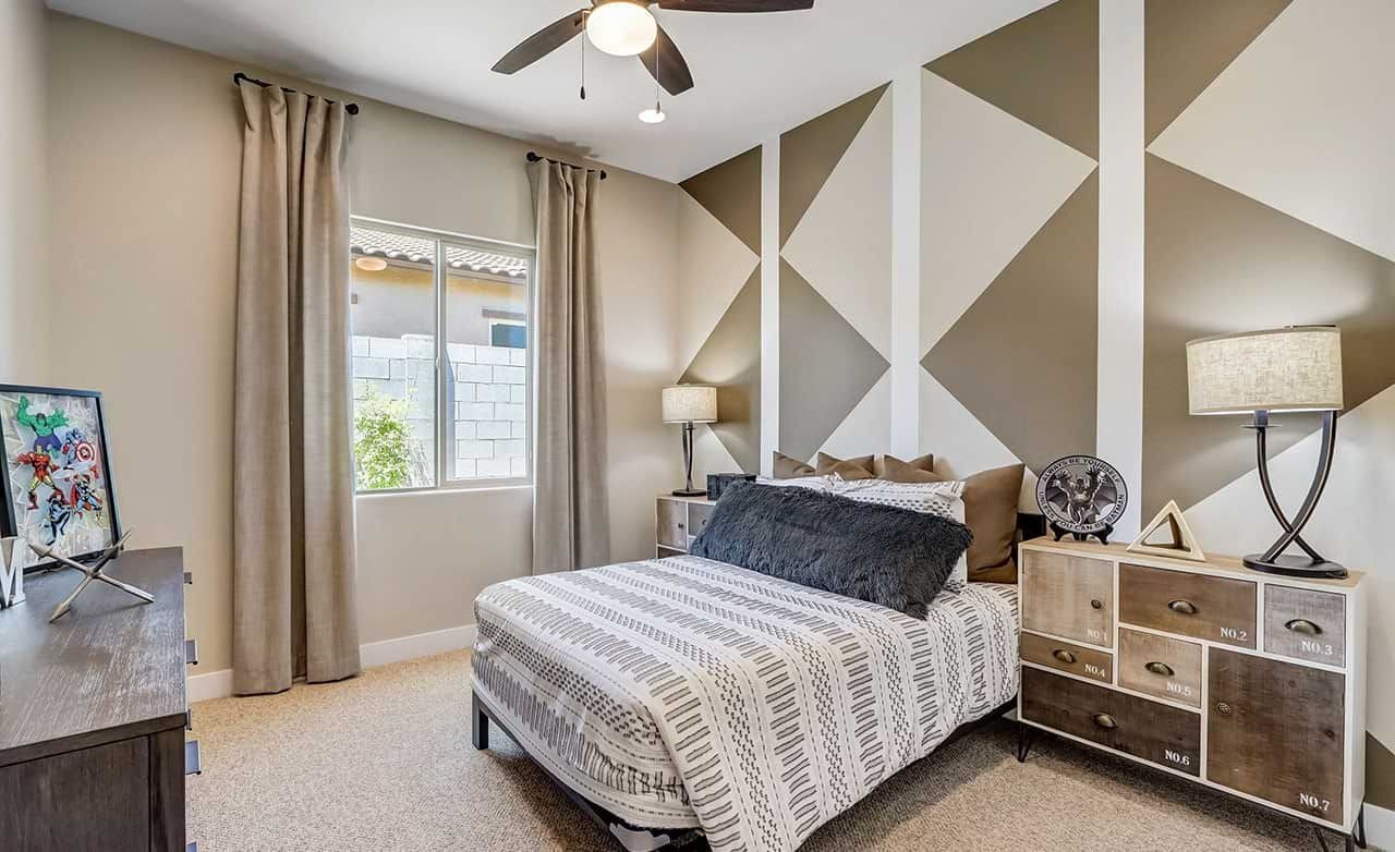 Modern Bedroom with Geometric Accent Wall in Hacienda Community Modern bedroom with geometric accent wall, elegant furniture, ceiling fan, Hacienda community.