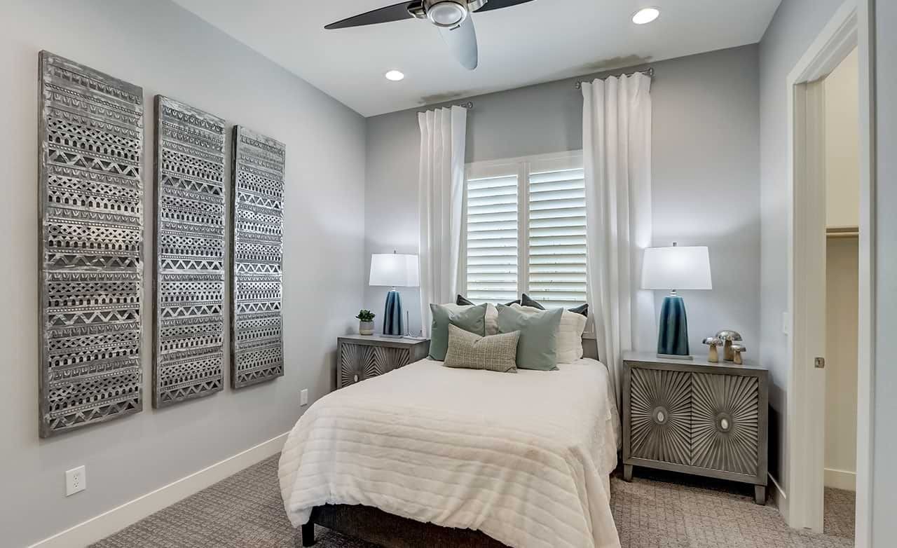 Hacienda Bedroom with Textured Wall Art and Ceiling Fan Modern bedroom in Hacienda, featuring textured wall art, dual nightstands, and ceiling fan. Neutral palette.