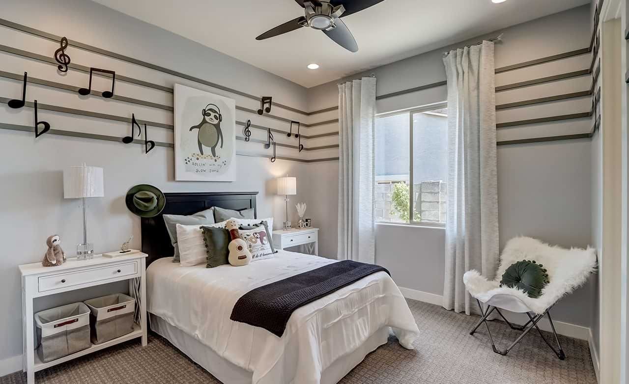 Music-Themed Bedroom with Decor in Canyon Views Hacienda Music-themed bedroom with musical note decor, modern furniture, large window, Canyon Views Hacienda community.