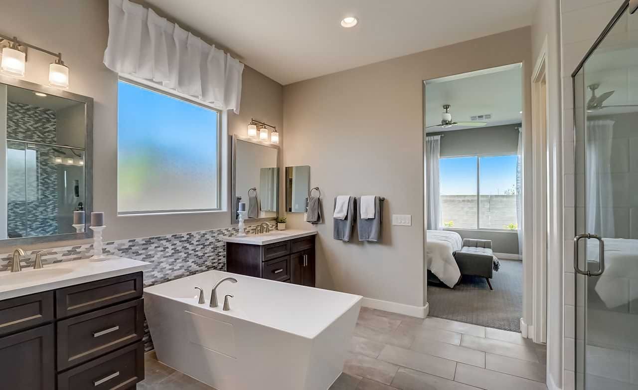 Luxurious Bathroom with Freestanding Tub in Hacienda Community Modern bathroom with sleek fixtures, dark wood cabinetry, freestanding tub in Hacienda community home.