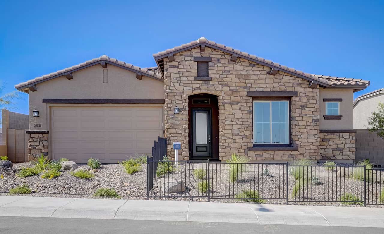 Stone Facade Home in Canyon Views Hacienda Community Single-story stone facade home, arched entrance, desert landscaping, Canyon Views - Hacienda community.