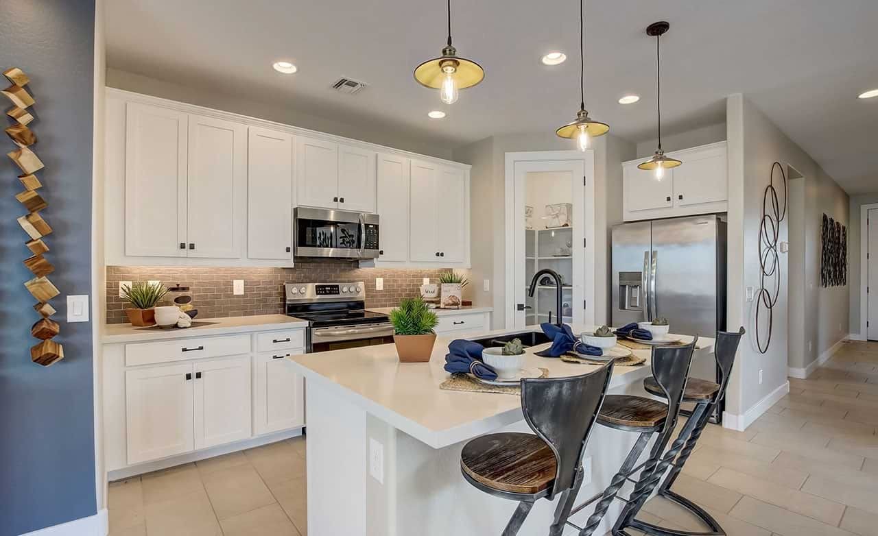 Modern Kitchen in Castillo at Anderson Parc, White Cabinets, Pendant Lights Modern kitchen in Castillo at Anderson Parc featuring white cabinets, pendant lighting, and stainless steel appliances.