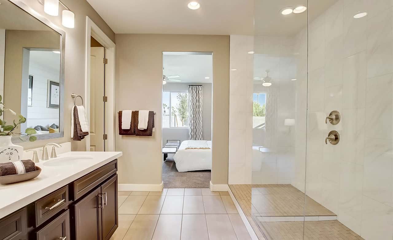 Luxurious Bathroom with Bedroom View at Castillo, Anderson Parc. Luxurious bathroom with double vanity, glass shower, and glimpse of bedroom at Castillo, Anderson Parc.