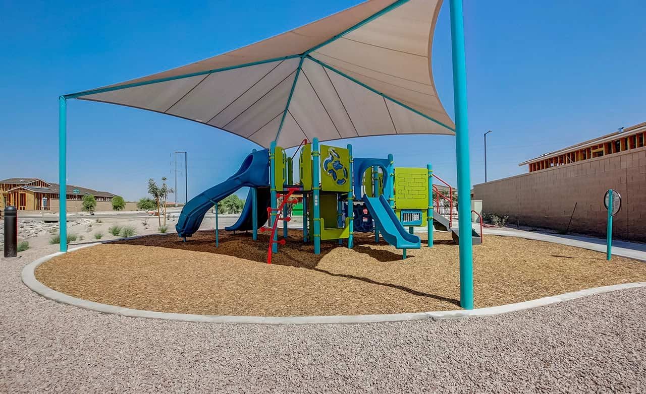 Playground with Shade Canopy at Castillo at Anderson Parc Vibrant playground with shade sail at Castillo at Anderson Parc, surrounded by new homes under construction.