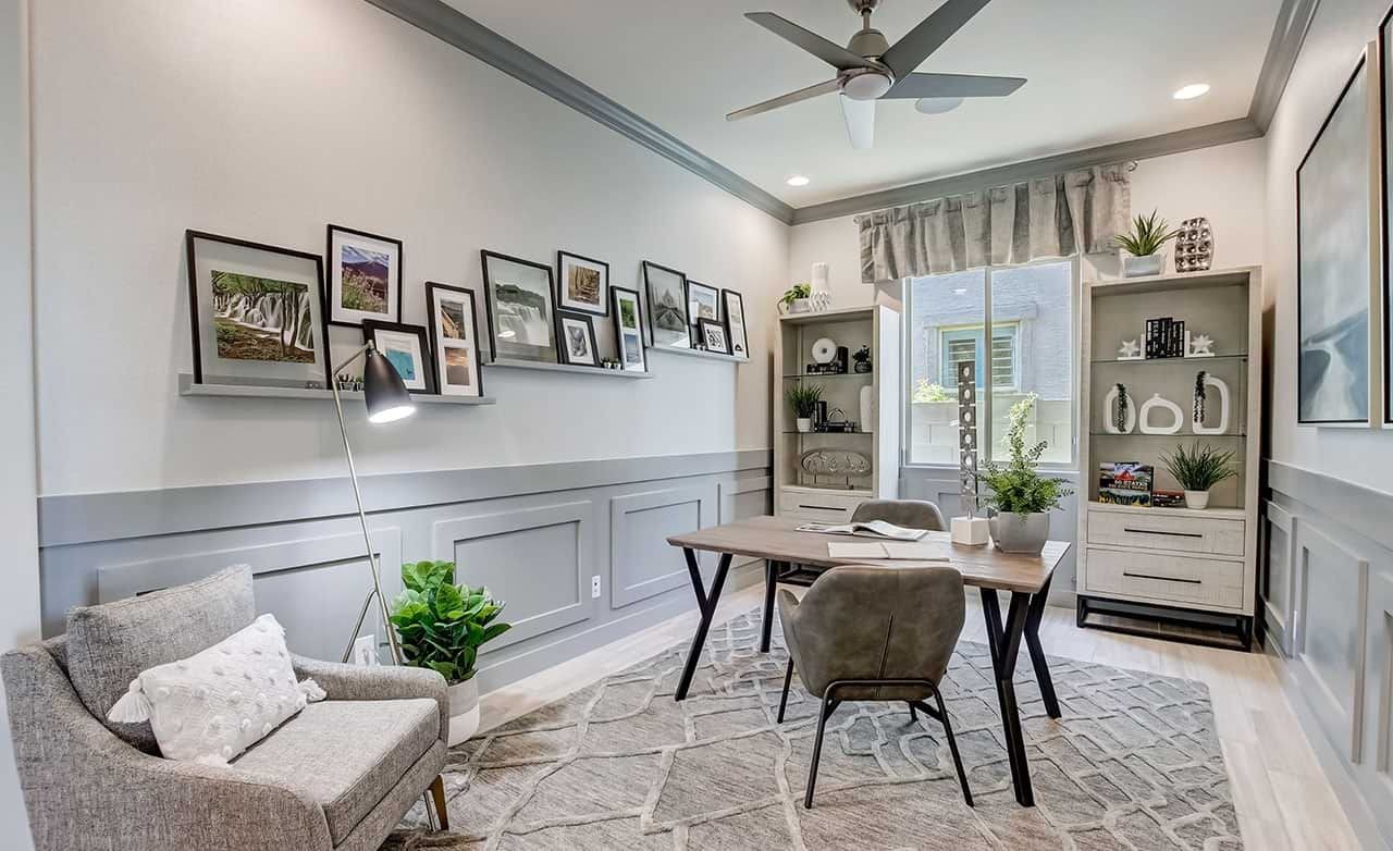 Modern Home Office Design in Mirada Crossing with Grey Paneling Chic home office with modern decor, framed photos, gray paneling, and large window in Mirada Crossing.